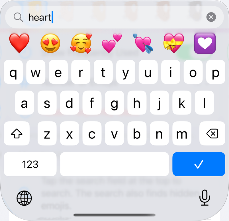 The Tidymoji keyboard after typing “heart” into the search field. Seven matching emojis appear above a letter keyboard.